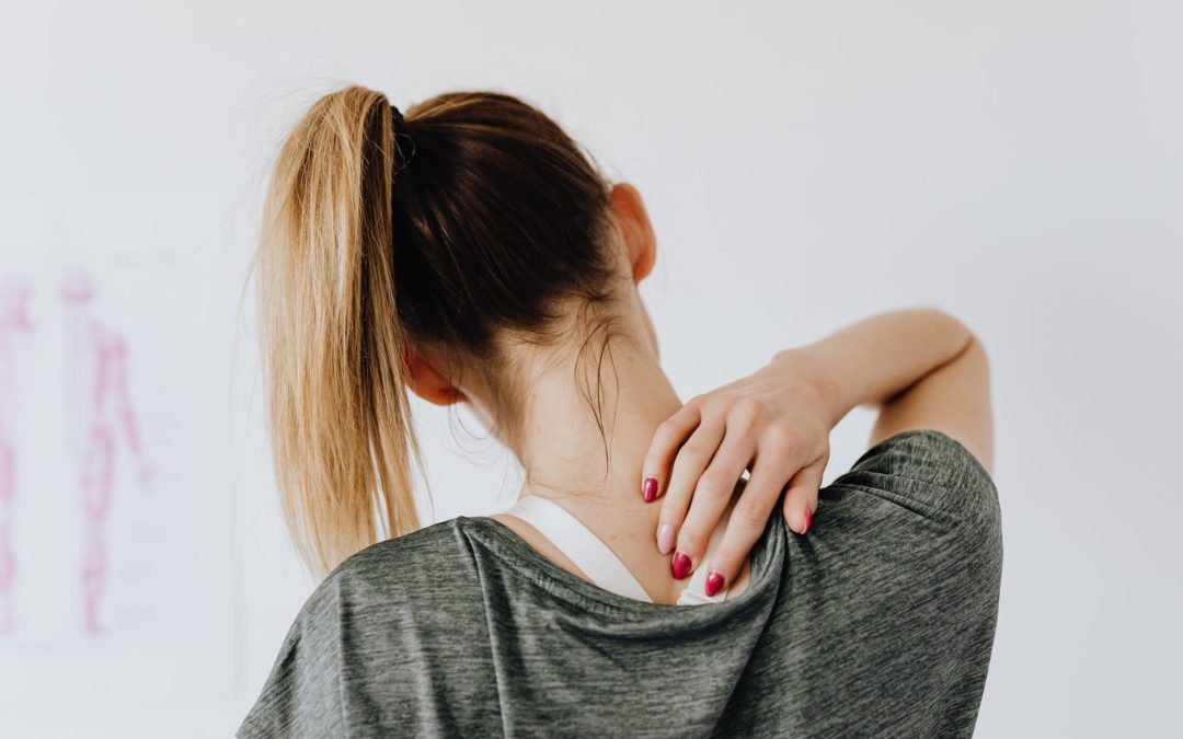 woman touching her back